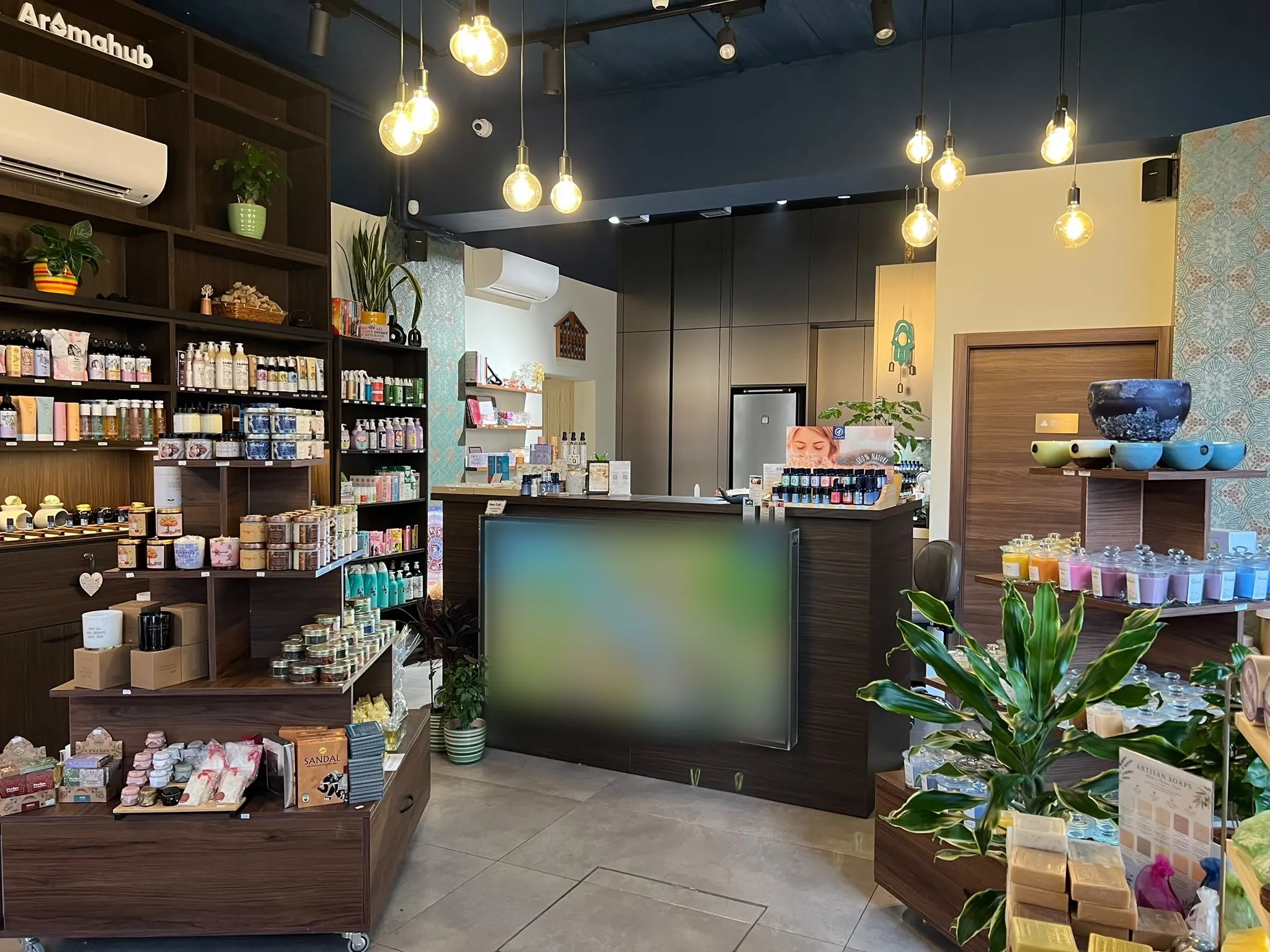 Inside the AromaHub shop in Naxxar: shelves of essential oils, candles and natural products